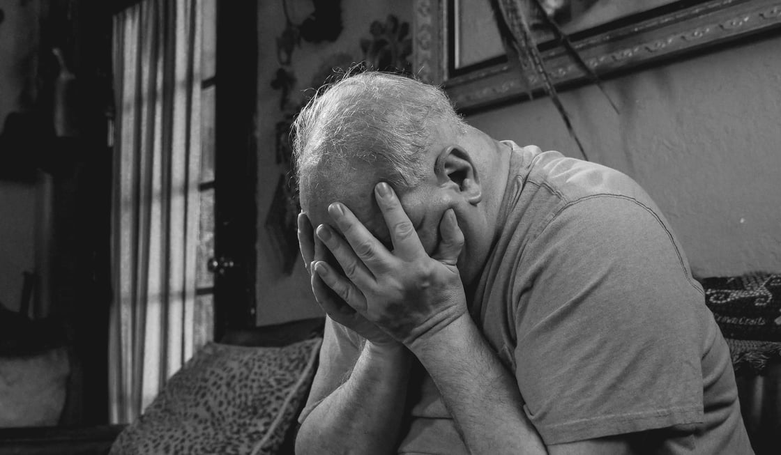 Man holding his head in his hands. Image: Unsplash